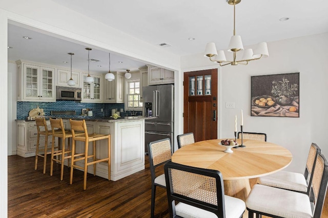 1118 Reagan Ter, Austin, TX 78704 - dining room with dark wood finished floors, a chandelier, and recessed lighting