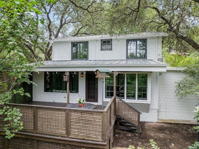 1118 Reagan Ter, Austin, TX 78704 - view of front facade featuring a metal roof, covered porch, a standing seam roof, and stairs