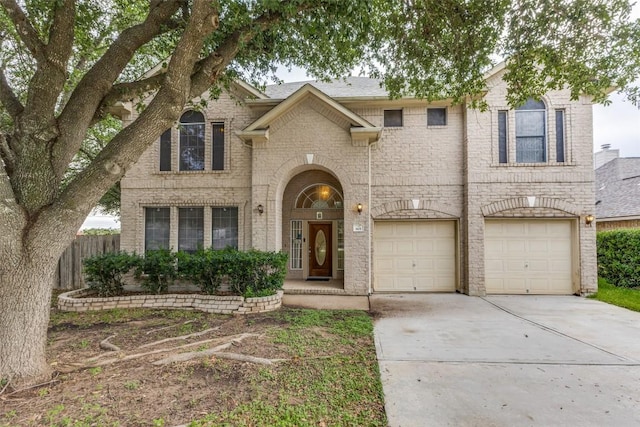 601 Indian Run Dr, Pflugerville, TX 78660 - view of front of house featuring driveway, brick siding, and an attached garage