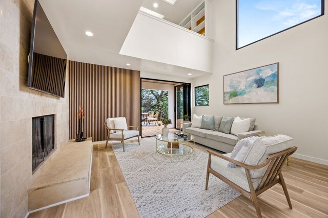 3704 Laurel Ledge Ln, Austin, TX 78731 - living area with light wood-style floors, a tiled fireplace, recessed lighting, and a towering ceiling