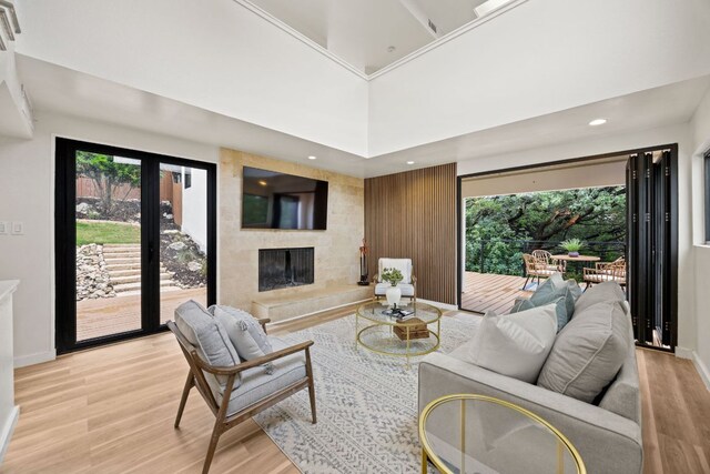 3704 Laurel Ledge Ln, Austin, TX 78731 - living area with light wood-style flooring, a large fireplace, recessed lighting, and a towering ceiling