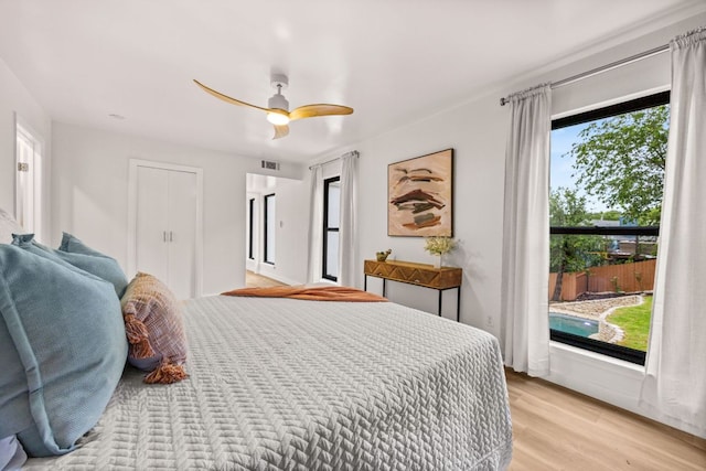 3704 Laurel Ledge Ln, Austin, TX 78731 - bedroom with light wood finished floors and ceiling fan