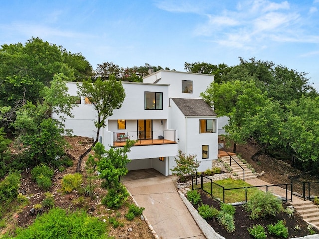 3704 Laurel Ledge Ln, Austin, TX 78731 - contemporary house with a carport, stucco siding, driveway, and stairway