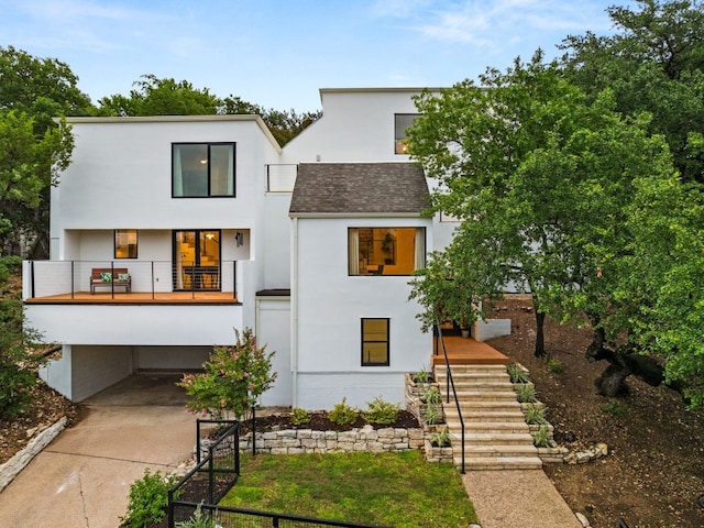 3704 Laurel Ledge Ln, Austin, TX 78731 - view of front of home featuring stairs, stucco siding, a shingled roof, a balcony, and a carport