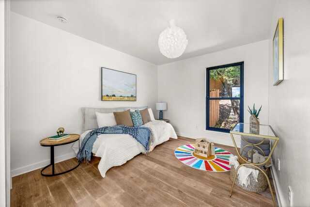 3704 Laurel Ledge Ln, Austin, TX 78731 - bedroom with a chandelier and wood finished floors