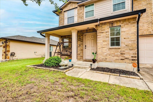 217 Adriana Ln, Hutto, TX 78634 - view of front of property with a front yard, covered porch, and a garage