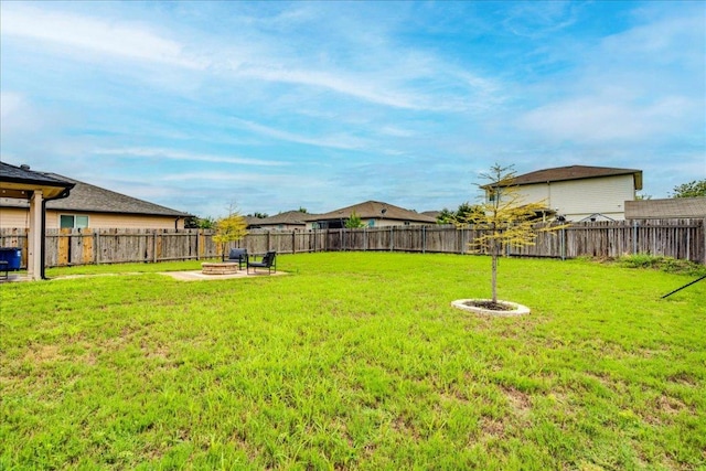 217 Adriana Ln, Hutto, TX 78634 - fenced backyard with a fire pit and a patio area