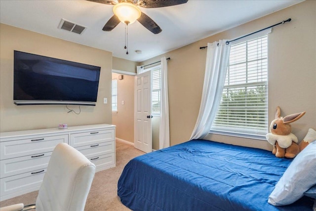 217 Adriana Ln, Hutto, TX 78634 - bedroom with light carpet, multiple windows, and a ceiling fan