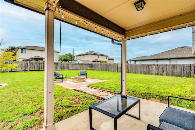 217 Adriana Ln, Hutto, TX 78634 - fenced backyard with an outdoor fire pit and a patio