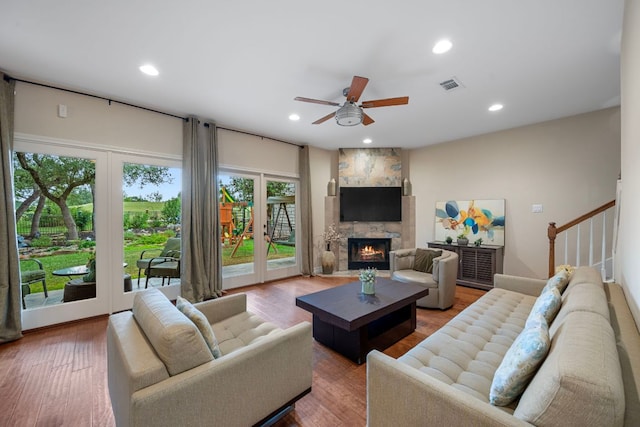 5715 Misty Hill Cv, Austin, TX 78759 - living area featuring a ceiling fan, a fireplace, recessed lighting, wood finished floors, and stairs