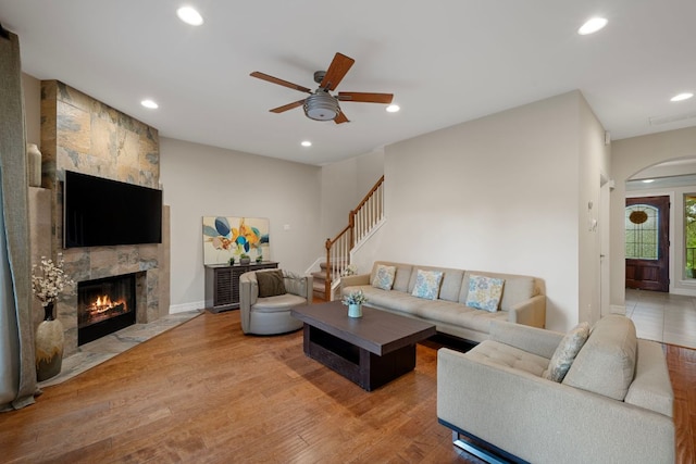 5715 Misty Hill Cv, Austin, TX 78759 - living room featuring arched walkways, recessed lighting, ceiling fan, a fireplace, and wood finished floors