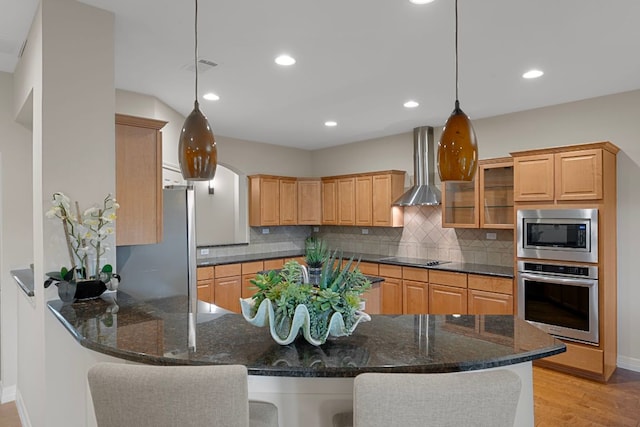 5715 Misty Hill Cv, Austin, TX 78759 - kitchen featuring appliances with stainless steel finishes, wall chimney exhaust hood, a peninsula, tasteful backsplash, and recessed lighting