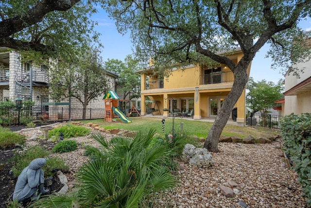 5715 Misty Hill Cv, Austin, TX 78759 - view of yard featuring a balcony, a playground, and a patio area
