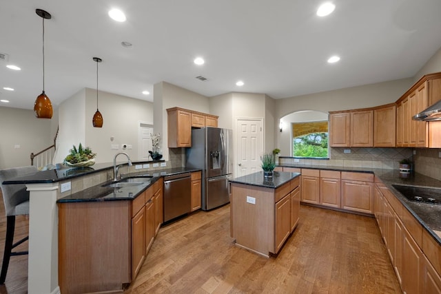 5715 Misty Hill Cv, Austin, TX 78759 - kitchen with stainless steel appliances, light wood-type flooring, a peninsula, a kitchen island, and recessed lighting