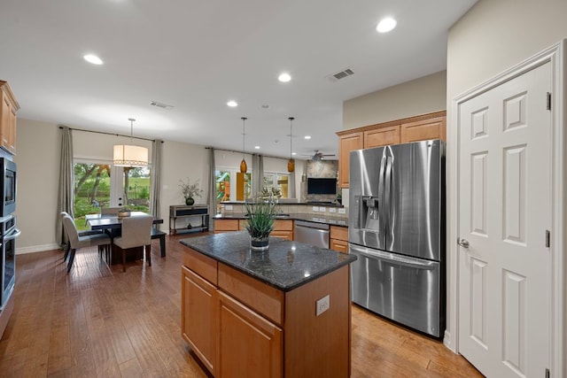 5715 Misty Hill Cv, Austin, TX 78759 - kitchen with appliances with stainless steel finishes, a center island, backsplash, decorative light fixtures, and recessed lighting
