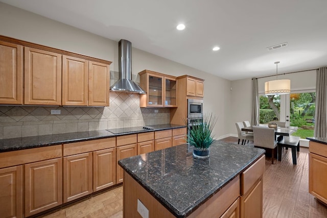 5715 Misty Hill Cv, Austin, TX 78759 - kitchen with wall chimney range hood, black appliances, backsplash, recessed lighting, and glass insert cabinets