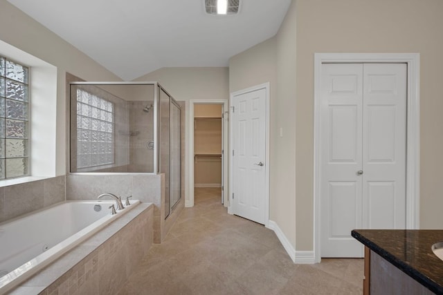 5715 Misty Hill Cv, Austin, TX 78759 - full bath featuring a stall shower, a garden tub, vanity, and lofted ceiling