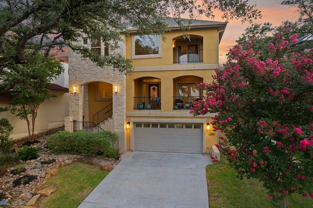 5715 Misty Hill Cv, Austin, TX 78759 - mediterranean / spanish home with a balcony, stucco siding, concrete driveway, an attached garage, and stone siding