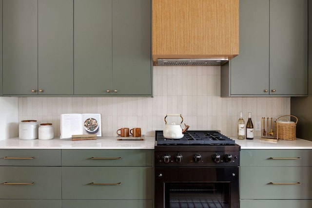 505 Philco Dr Unit 3, Austin, TX 78745 - kitchen with black gas range oven, green cabinetry, backsplash, ventilation hood, and light countertops