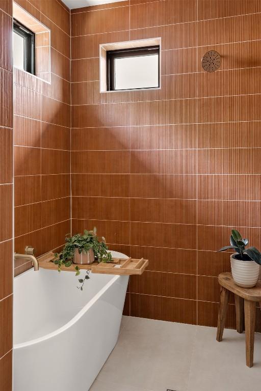 505 Philco Dr Unit 3, Austin, TX 78745 - bathroom featuring a soaking tub and tile walls