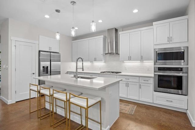 4602 Alf Ave Unit B, Austin, TX 78721 - kitchen featuring stainless steel appliances, wall chimney range hood, finished concrete flooring, decorative backsplash, and light countertops