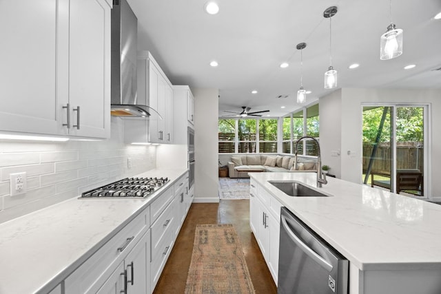 4602 Alf Ave Unit B, Austin, TX 78721 - kitchen featuring stainless steel appliances, wall chimney exhaust hood, decorative backsplash, open floor plan, and recessed lighting