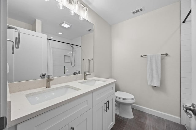 4602 Alf Ave Unit B, Austin, TX 78721 - bathroom with double vanity, a shower, and wood finished floors