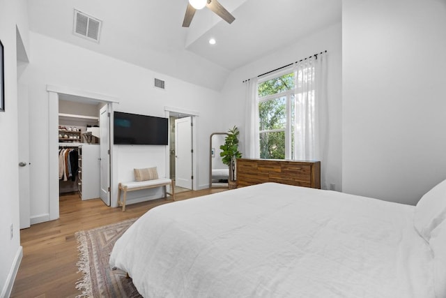 4602 Alf Ave Unit B, Austin, TX 78721 - bedroom featuring vaulted ceiling, wood finished floors, a walk in closet, a ceiling fan, and recessed lighting
