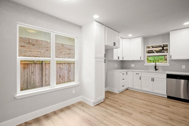 11462 Bristle Oak Trl, Austin, TX 78750 - kitchen with stainless steel dishwasher, light wood-type flooring, white cabinetry, light countertops, and recessed lighting