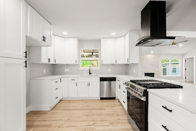 11462 Bristle Oak Trl, Austin, TX 78750 - kitchen featuring stainless steel appliances, island exhaust hood, plenty of natural light, a ceiling fan, and recessed lighting