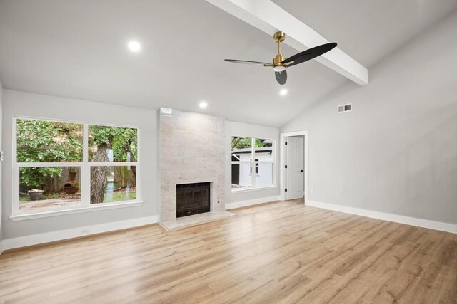 11462 Bristle Oak Trl, Austin, TX 78750 - unfurnished living room with beamed ceiling, light wood-style flooring, plenty of natural light, a tile fireplace, and recessed lighting