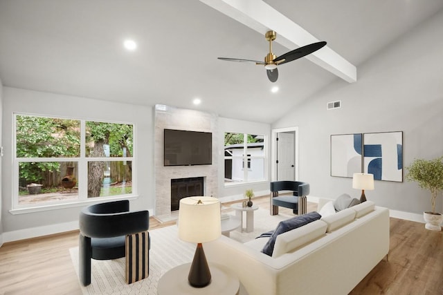 11462 Bristle Oak Trl, Austin, TX 78750 - living room with beam ceiling, wood finished floors, a large fireplace, recessed lighting, and a ceiling fan