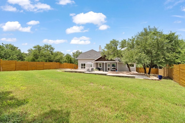 503 Alva Dr, Spicewood, TX 78669 - back of house featuring a fenced backyard, a chimney, and a patio area