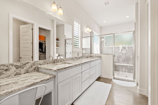 503 Alva Dr, Spicewood, TX 78669 - bathroom featuring a shower stall, double vanity, a spacious closet, recessed lighting, and finished concrete flooring