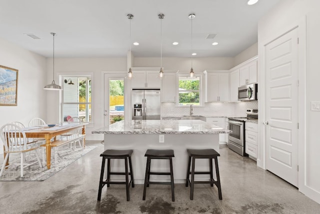 503 Alva Dr, Spicewood, TX 78669 - kitchen featuring stainless steel appliances, concrete flooring, backsplash, a kitchen island, and recessed lighting
