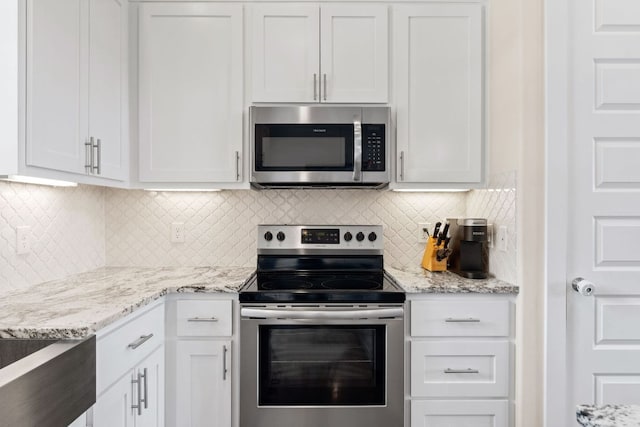 503 Alva Dr, Spicewood, TX 78669 - kitchen with appliances with stainless steel finishes, light stone counters, tasteful backsplash, and white cabinets