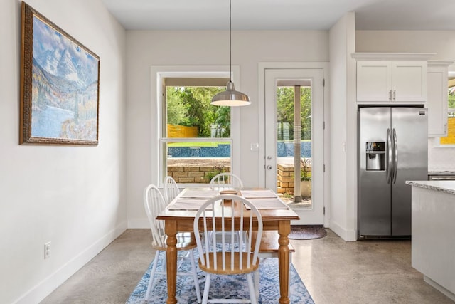 503 Alva Dr, Spicewood, TX 78669 - dining area with finished concrete flooring and baseboards