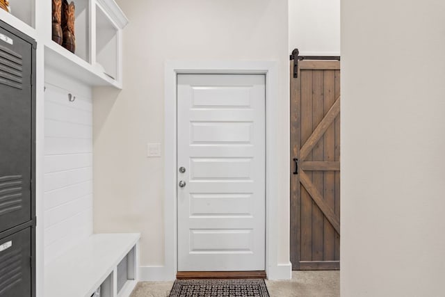 503 Alva Dr, Spicewood, TX 78669 - mudroom with a barn door and baseboards