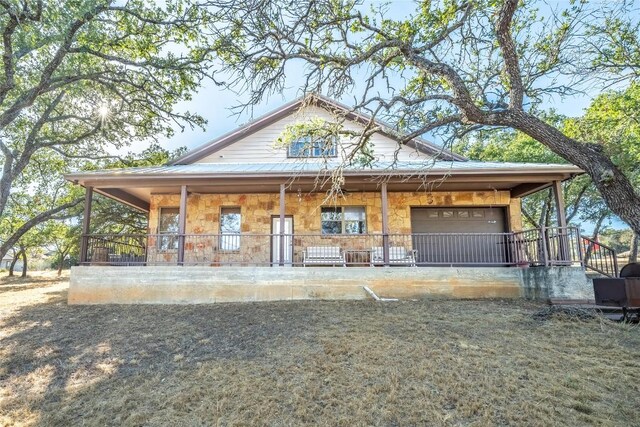 103 Rolling Hills Dr, Spicewood, TX 78669 - view of front of house featuring stone siding and a garage
