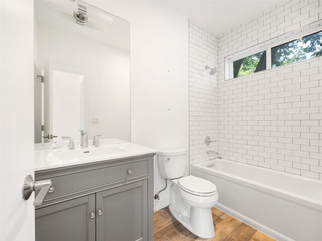 1605 Garden St, Austin, TX 78702 - full bath featuring vanity, wood finished floors, and washtub / shower combination