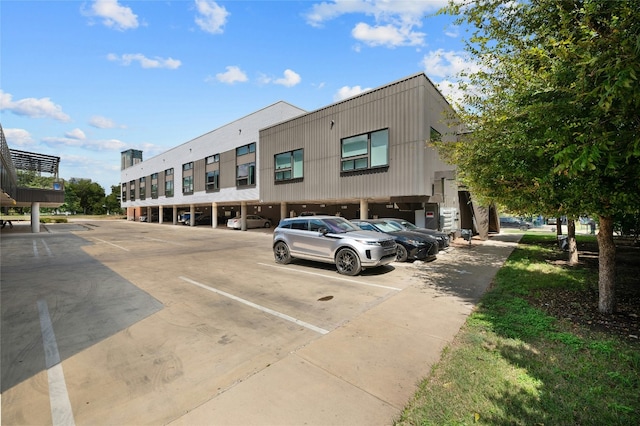 49 Navasota St Unit 216, Austin, TX 78702 - view of building exterior with covered and uncovered parking