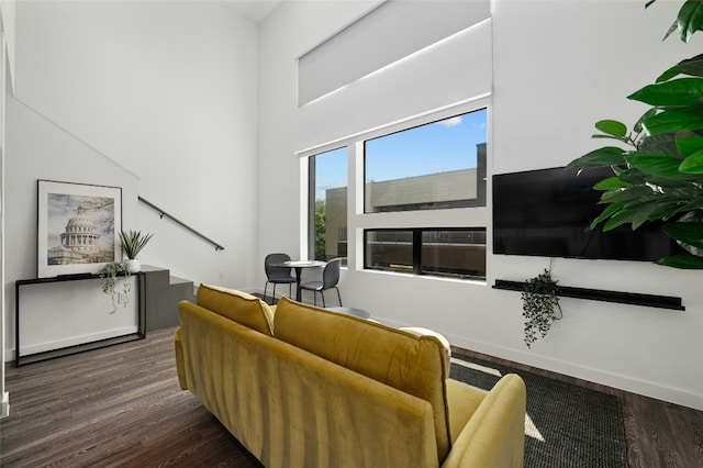 49 Navasota St Unit 216, Austin, TX 78702 - living area featuring dark wood-style flooring and a towering ceiling