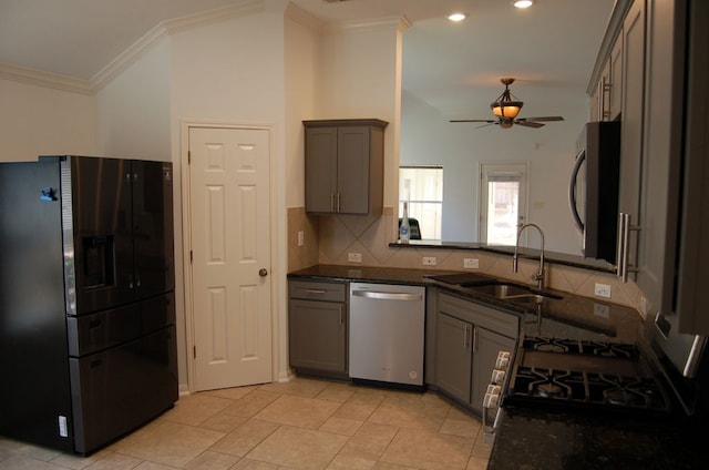 4216 Veiled Falls Dr, Pflugerville, TX 78660 - kitchen with appliances with stainless steel finishes, ceiling fan, gray cabinets, ornamental molding, and dark stone counters
