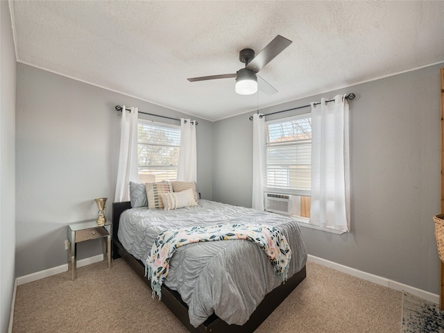 3908 Boat Dock Rd, Lago Vista, TX 78645 - bedroom with multiple windows, a textured ceiling, cooling unit, carpet, and a ceiling fan