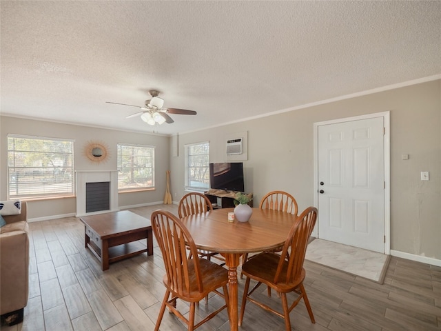 3908 Boat Dock Rd, Lago Vista, TX 78645 - dining room with a textured ceiling, light wood-type flooring, ceiling fan, healthy amount of natural light, and crown molding