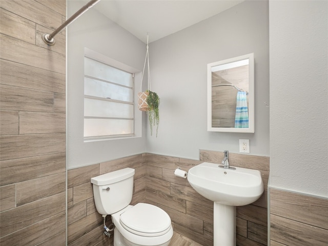 3908 Boat Dock Rd, Lago Vista, TX 78645 - bathroom with tile walls, a shower with shower curtain, and wainscoting