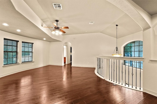 2908 Arbor Ct, Round Rock, TX 78681 - unfurnished living room with arched walkways, ceiling fan, wood finished floors, lofted ceiling, and recessed lighting