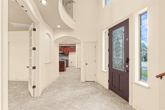 2908 Arbor Ct, Round Rock, TX 78681 - foyer with light tile patterned flooring, arched walkways, and recessed lighting