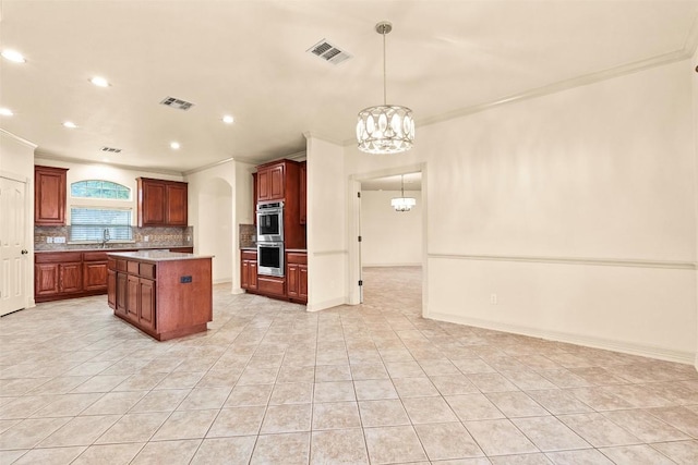 2908 Arbor Ct, Round Rock, TX 78681 - kitchen with a chandelier, stainless steel double oven, crown molding, light countertops, and tasteful backsplash