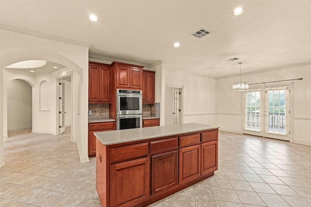2908 Arbor Ct, Round Rock, TX 78681 - kitchen featuring arched walkways, stainless steel double oven, light tile patterned flooring, light countertops, and recessed lighting